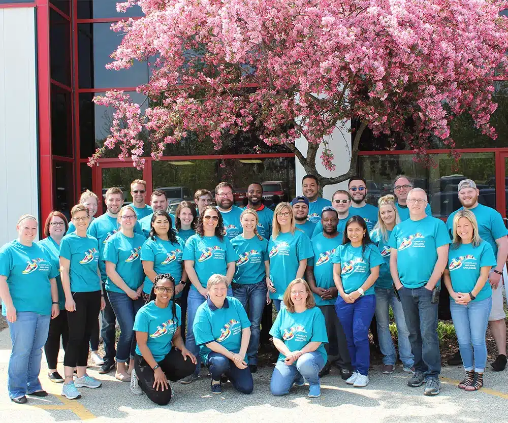 Team photo with pink blossom tree